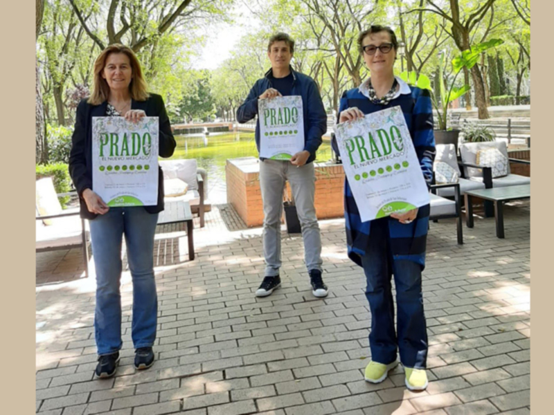 Celebración del lanzamiento de 'Prado: El Nuevo Mercado' en un parque soleado.