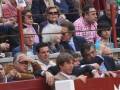 Spectators in a bullfighting arena, engaged and observing the event.