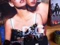 An advertisement featuring models wearing stylish sunglasses with the logo 'D&G' prominently displayed.
