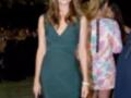 Mujer con vestido verde en evento nocturno al aire libre.