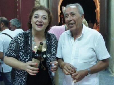 Amigos compartiendo una botella de vino en una fiesta al aire libre.